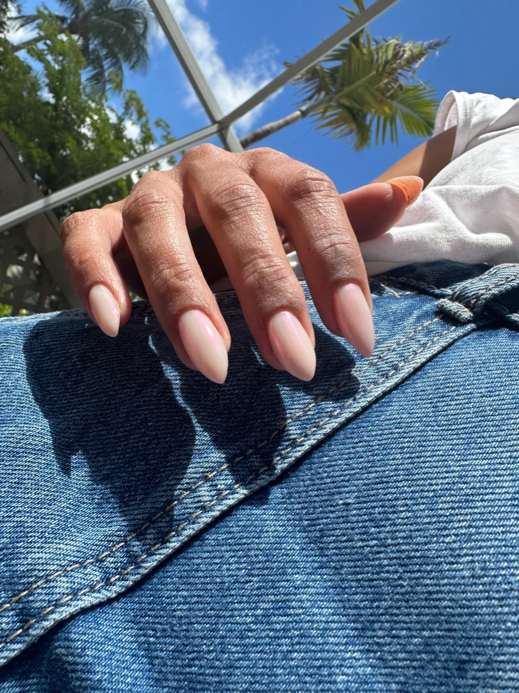 Pale reflective chrome manicure photographed outdoors